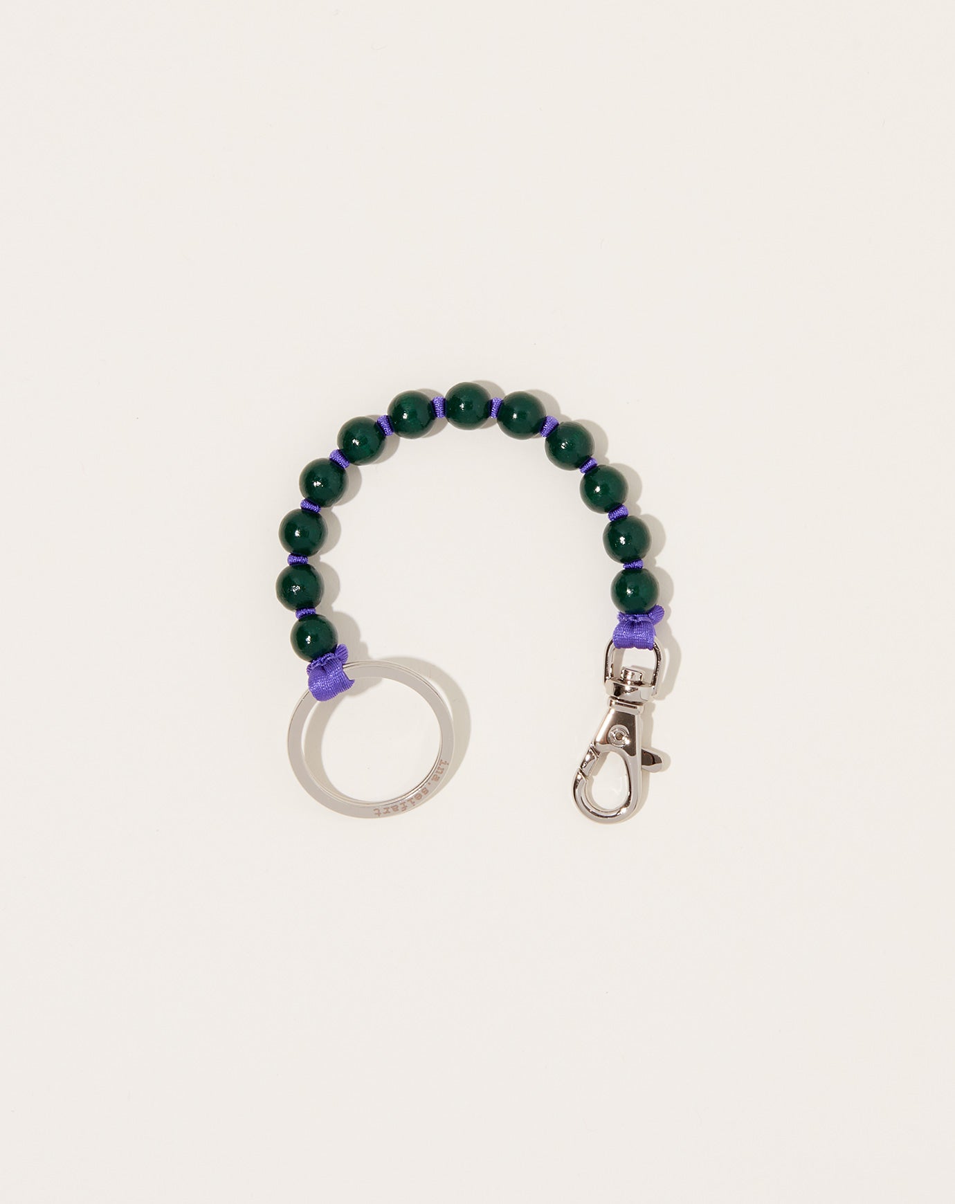 Ina Seifart Perlen Short Keyholder in Dark Green on Purple