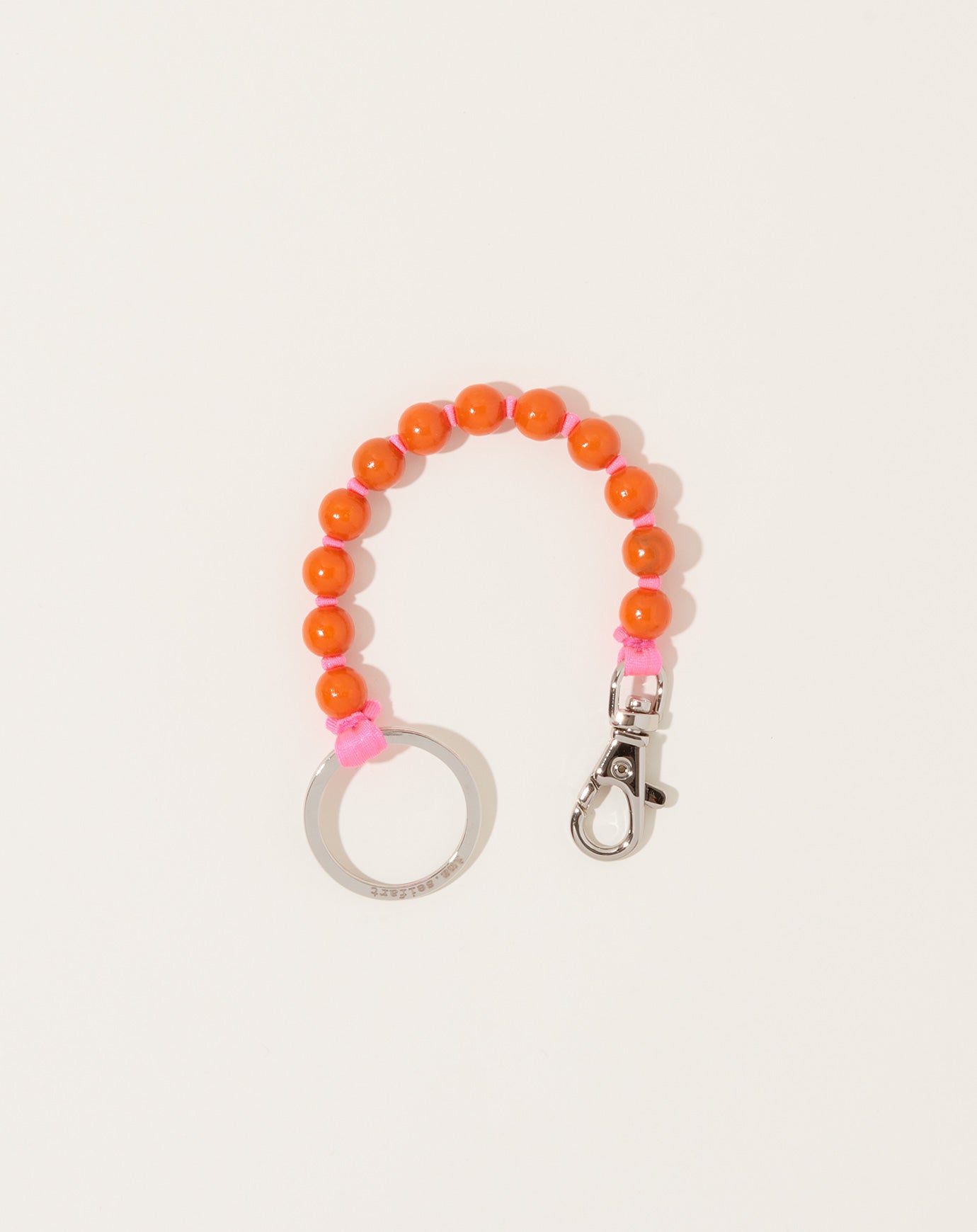 Ina Seifart Perlen Short Keyholder in Orange on Neon Pink