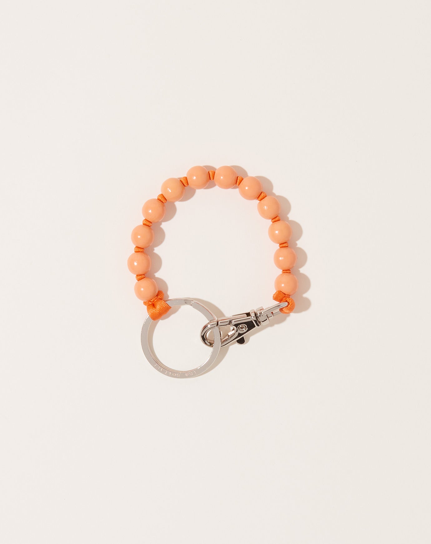 Ina Seifart Perlen Short Keyholder in Peach on Orange