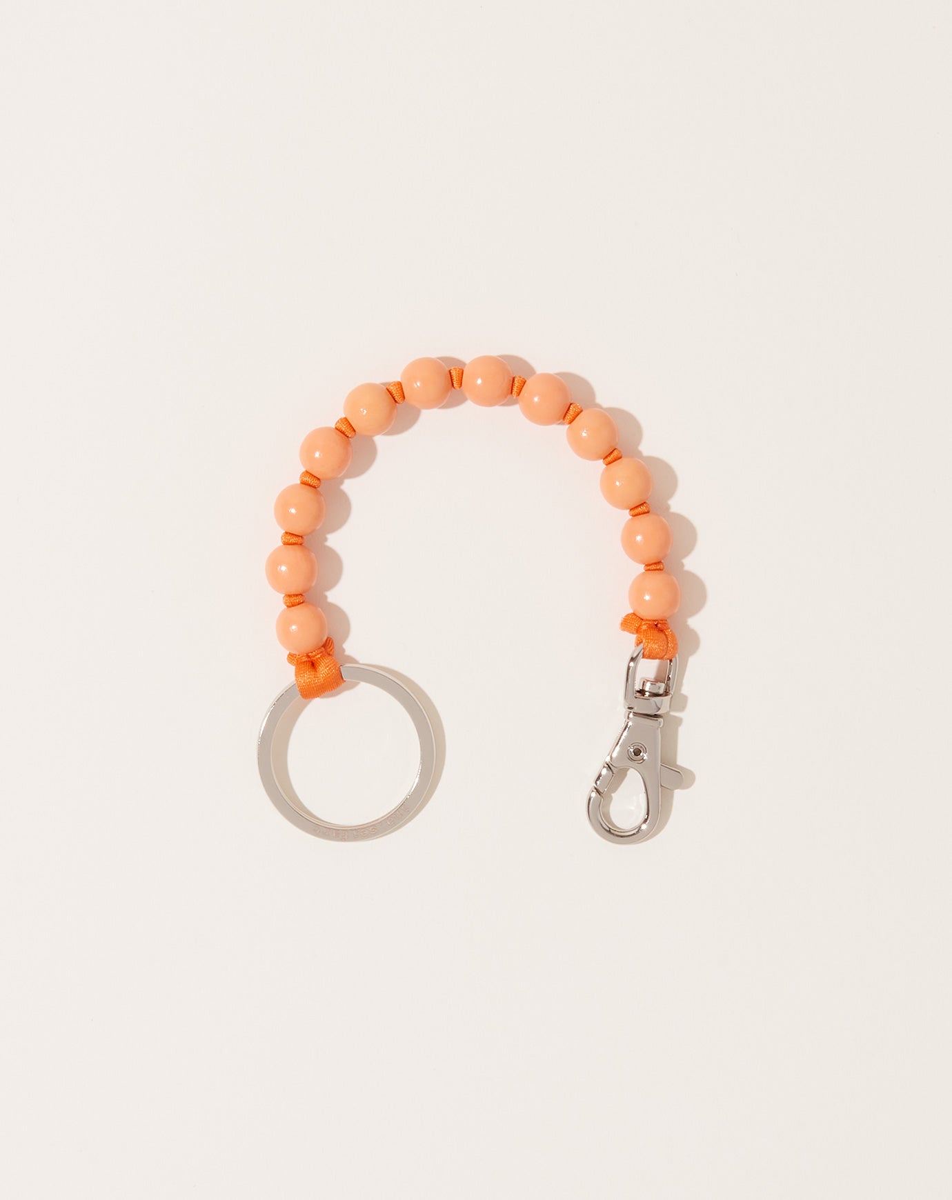 Ina Seifart Perlen Short Keyholder in Peach on Orange