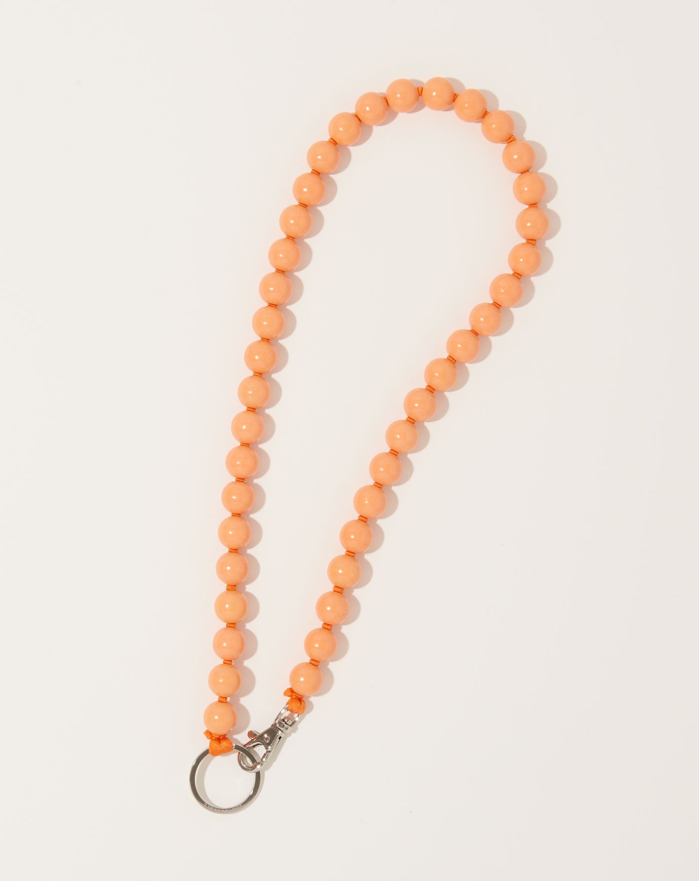 Ina Seifart Big Perlen Long Keyholder in Peach on Orange