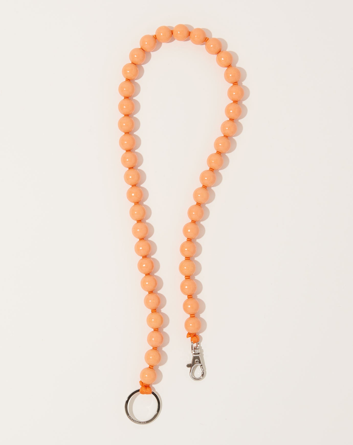 Ina Seifart Big Perlen Long Keyholder in Peach on Orange