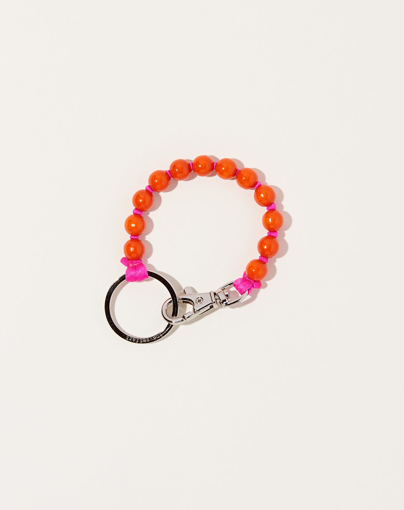 Ina Seifart Perlen Short Keyholder in Orange on Pink