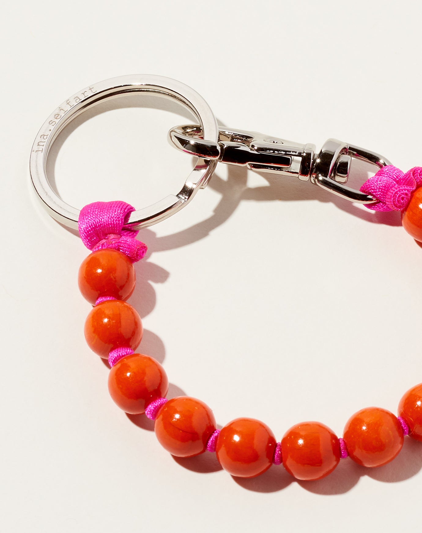 Ina Seifart Perlen Short Keyholder in Orange on Pink